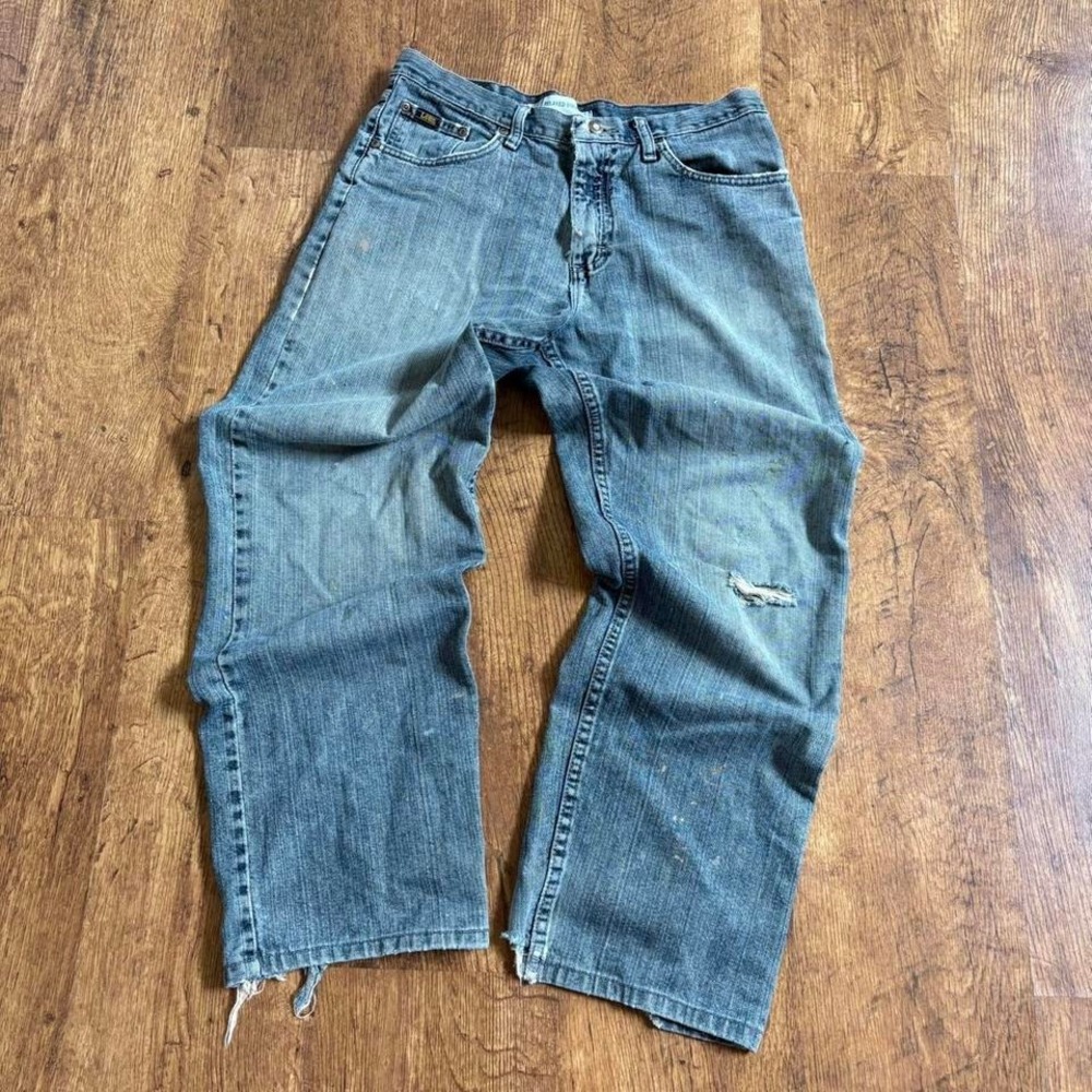 Distressed and paint‎ stained vintage style Lee denim jeans with a relaxed fit,